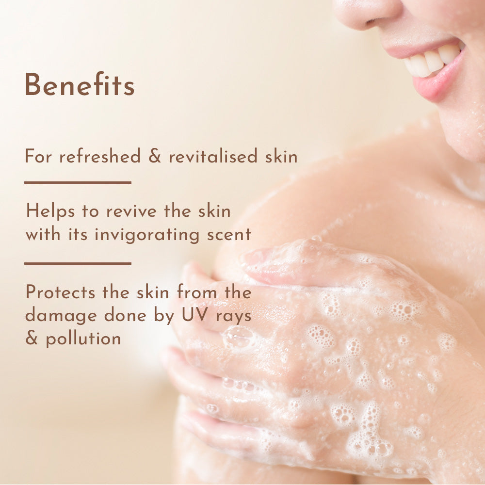 Close-up of a smiling person lathering shoulder with foamy body wash; overlay text lists Benefits like refreshed skin and protection from UV and pollution.