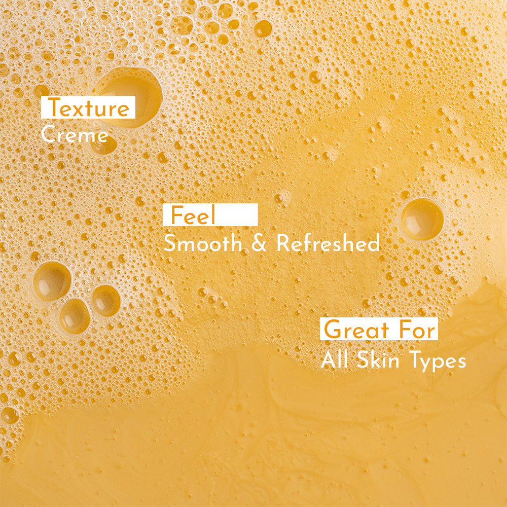 Detailed shot of best mango body wash with scattered bubbles, featuring creme texture, smooth and refreshed feel and great for all skin types.