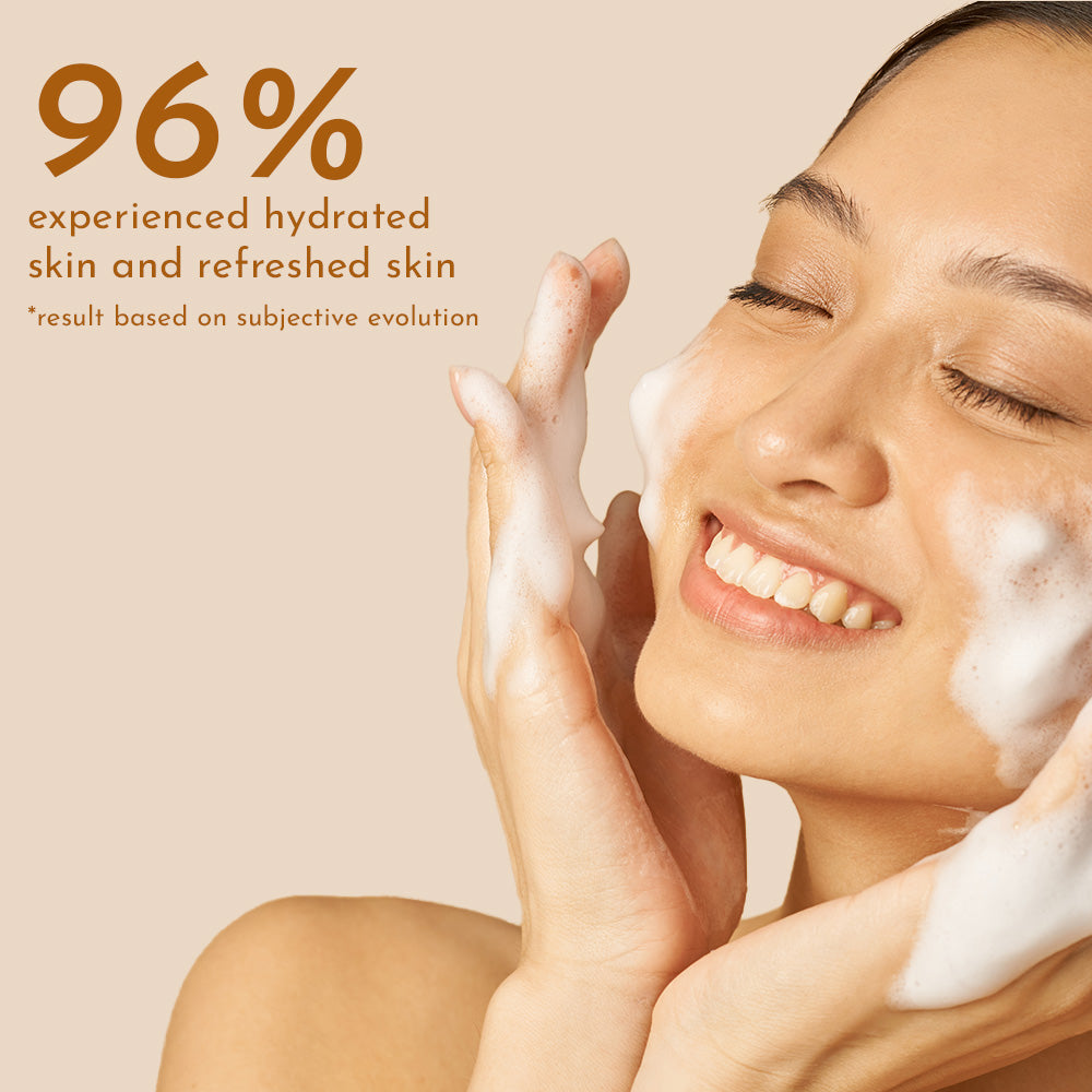A smiling woman with her eyes closed, happily washing her face with best 24k gold face wash, next to a statistic stating "96% experienced hydrated and refreshed skin.
