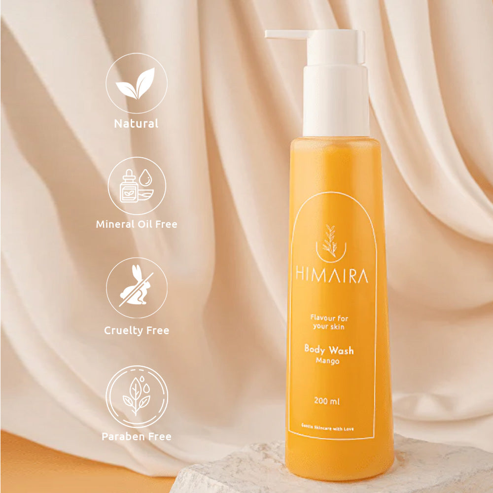 Himaira Mango Body Wash bottle placed on stone with draped beige backdrop with icons; read Natural, Mineral Oil Free, Cruelty Free and Paraben Free.