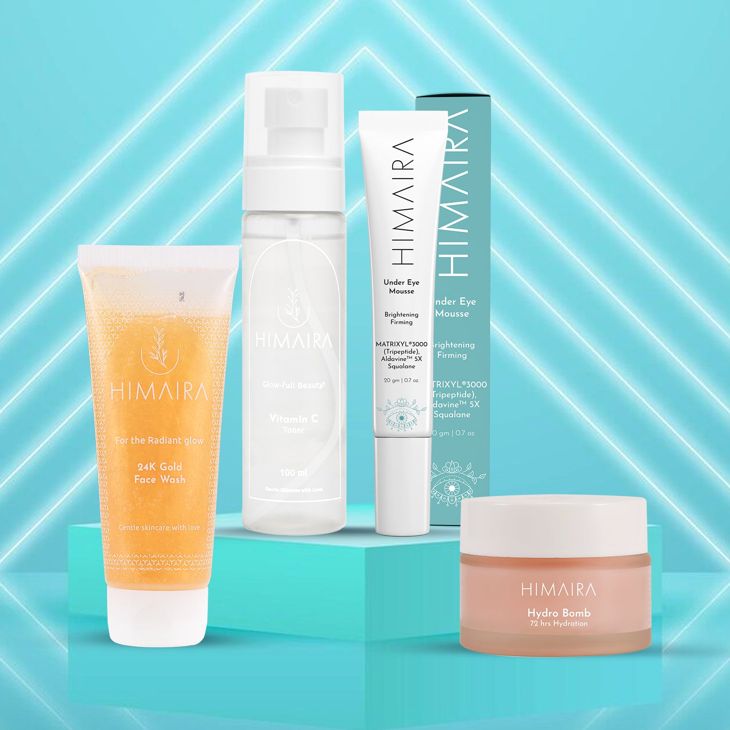 Himaira Dream Routine set is shown against bright aqua background; 24K Gold Face Wash, Vitamin C Toner, Under Eye Mousse, Hydro Bomb jar.