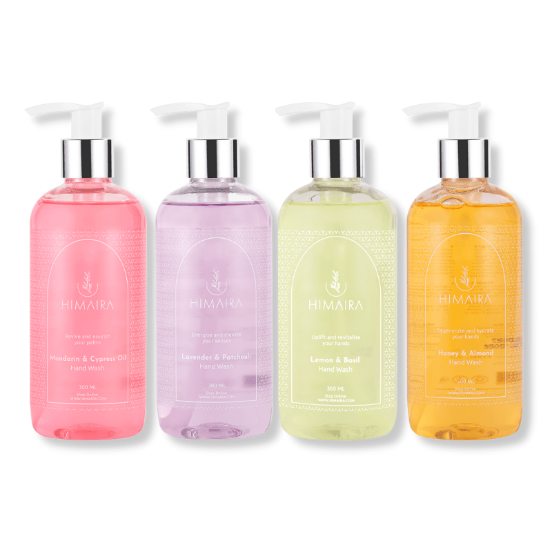 Four hand wash bottle; pink, lavender, tan brown and saffron mango color with pump in each bottle, showcasing wide range of Himaira&