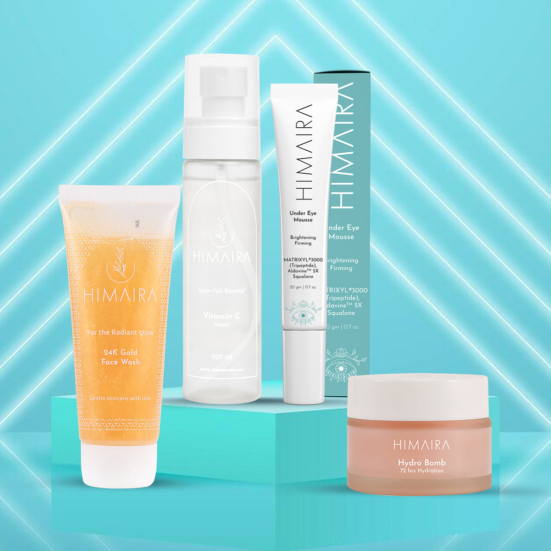 Himaira Dream Routine set is shown against bright aqua background; 24K Gold Face Wash, Vitamin C Toner, Under Eye Mousse, Hydro Bomb jar.